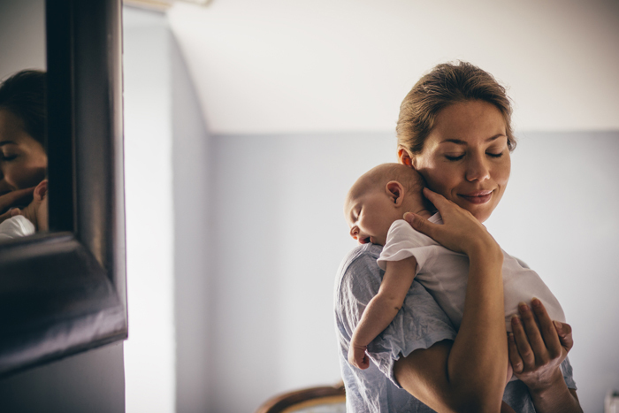 Mother holding young baby